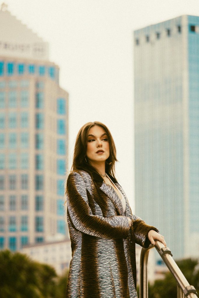 Elegant woman posing against a city backdrop in Tampa.